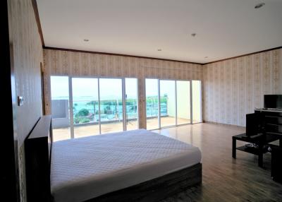 Spacious bedroom with large windows and scenic view