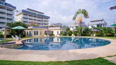 Residential complex with large outdoor swimming pool and surrounding lounging areas