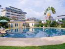 Residential complex with large outdoor swimming pool and surrounding lounging areas