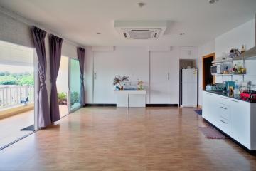 Spacious open plan living room and kitchen with natural light