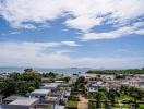 Panoramic view of a coastal area showing residential neighborhood with sea and sky