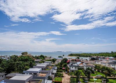 Panoramic view of a coastal area showing residential neighborhood with sea and sky