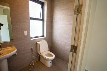 Compact bathroom with modern fixtures and large window