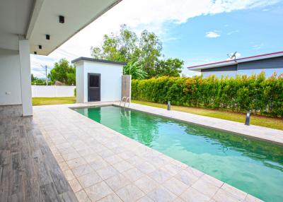 Private pool with tiled poolside and garden view