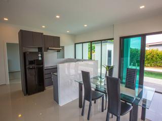 Modern kitchen with dining area and sliding glass doors