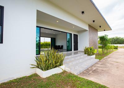 Modern single-story house with spacious front porch and sliding glass doors