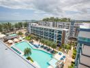 Resort-style apartment complex with swimming pool and ocean view