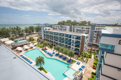 Resort-style apartment complex with swimming pool and ocean view