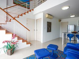 Spacious interior with staircase, modern furniture, and bright decor