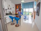 Modern kitchen with high bar stools and staircase