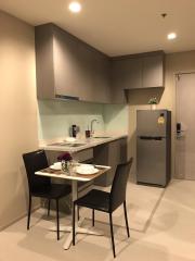 Modern kitchen with stainless steel appliances and a small dining area