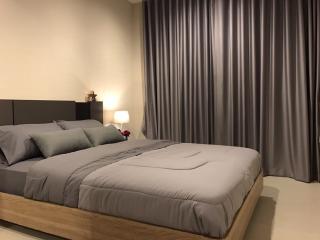 Cozy modern bedroom with queen-sized bed and gray color scheme