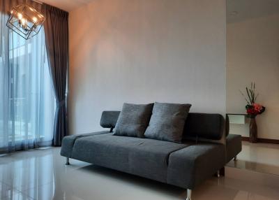 Modern minimalist living room with comfortable sofa and stylish lighting