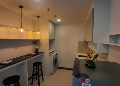 Modern kitchen with bar seating and stainless steel appliances