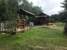 Rural house exterior with garden and gazebo