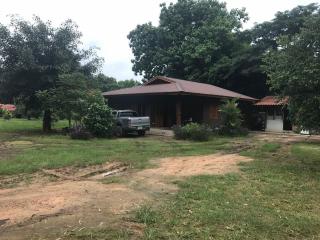 rural house with a truck parked outside and surrounding greenery