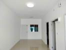 Bright empty room with tiled flooring and white walls