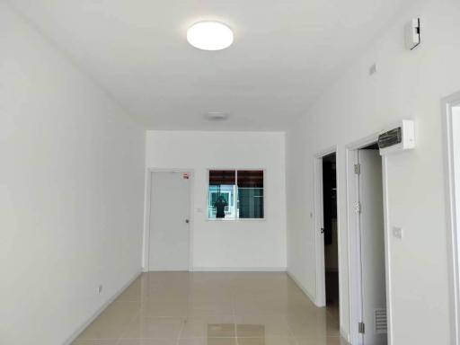 Bright empty room with tiled flooring and white walls