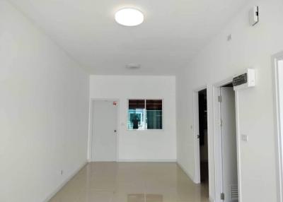 Bright empty room with tiled flooring and white walls
