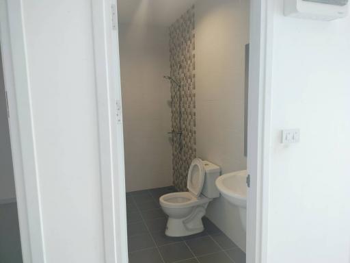 Modern bathroom with decorative tiled wall and white fixtures