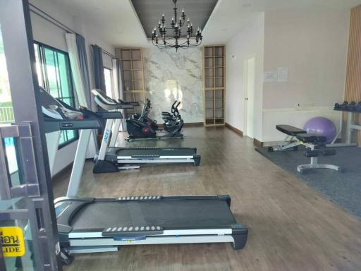 Spacious home gym with modern equipment and large windows