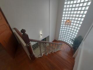 Bright and modern staircase with wooden steps and glass blocks wall