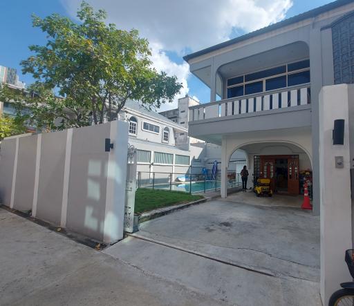 Modern two-story house with a swimming pool and balcony