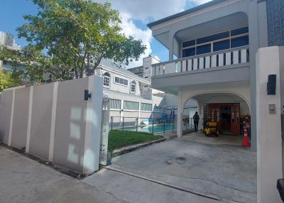 Modern two-story house with a swimming pool and balcony