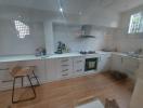 Modern kitchen with white cabinetry and built-in appliances