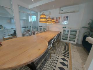 Spacious dining area with modern lighting and patterned floor