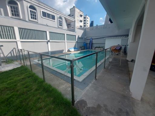 Private outdoor area with a small swimming pool and city buildings in the background