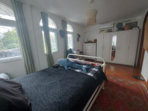 Cozy bedroom with large windows and natural light