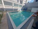 Residential outdoor swimming pool with surrounding area