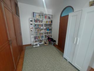 Cozy bedroom with a large bookshelf and ample storage space