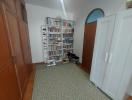 Cozy bedroom with a large bookshelf and ample storage space