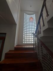 Staircase with natural light filtering through glass blocks