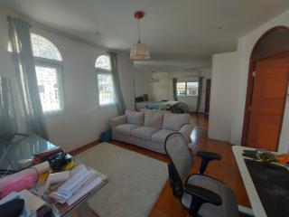 Spacious living room with large windows and comfortable seating