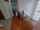 Spacious hallway with tiled flooring and safety netting along the stairwell