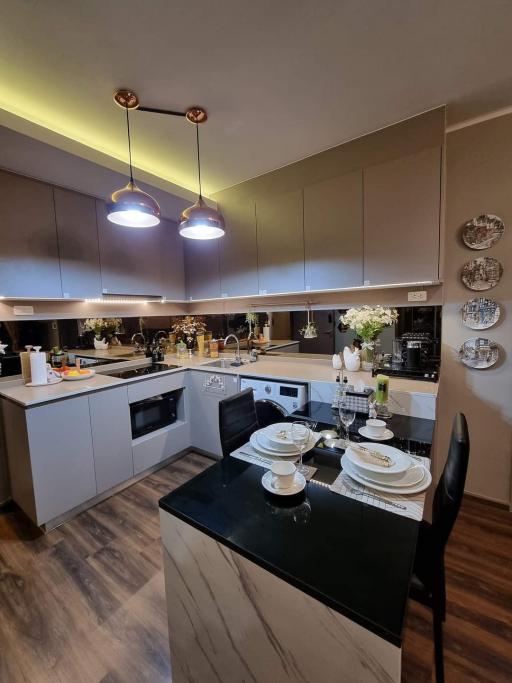 Modern kitchen with LED lighting and dinner table set for two