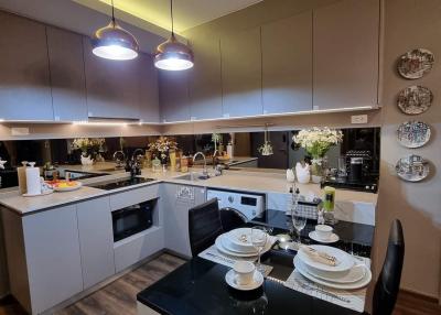 Modern kitchen with LED lighting and dinner table set for two