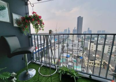 Cosy balcony with artificial grass overlooking the cityscape