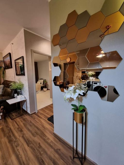 Stylish living area with modern honeycomb mirror wall decoration and hardwood flooring