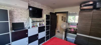 Modern bedroom interior with red accents and entertainment unit