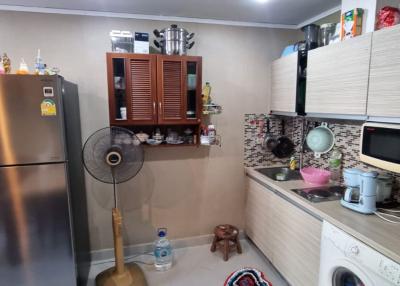 Modern kitchen with stainless steel appliances and a laundry area