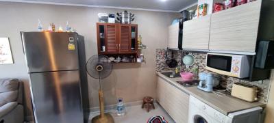 Modern kitchen with stainless steel appliances and a laundry area