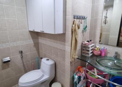 Compact bathroom with modern fixtures and wall-mounted storage