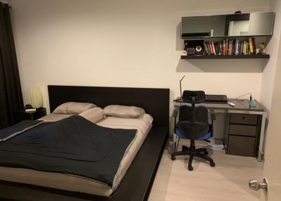 Cozy modern bedroom with a large bed and a work station