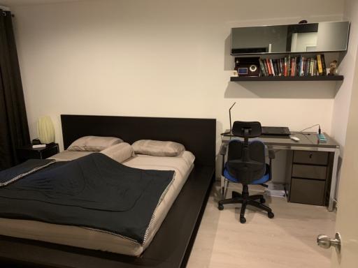 Cozy modern bedroom with a large bed and a work station