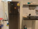 Compact kitchen with stainless steel refrigerator and modern amenities