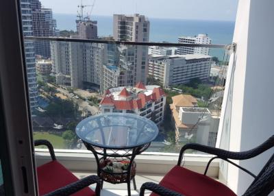 Cozy balcony with sea view, glass table and two chairs